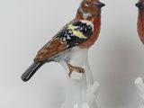 two figurines of birds sitting on top of each other