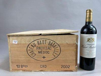 a wooden box with a bottle of wine inside of it