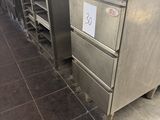 stainless steel kitchen island with drawers and drawers in a commercial kitchen