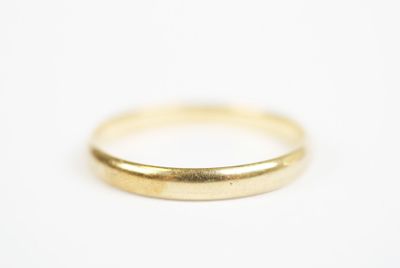 a close up of a gold ring on a white surface