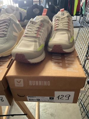 two pairs of running shoes on top of a box