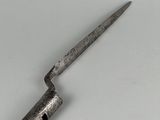 a close up of a knife on a table with a white background