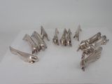 seven pieces of silverware sitting on a white surface