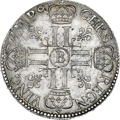 a silver coin with a cross and crown on it