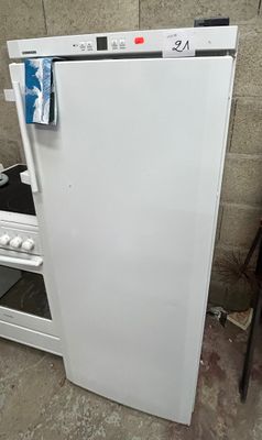 a white refrigerator sitting in the corner of a room