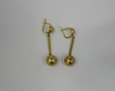 a pair of gold earrings on a white background