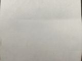 an old piece of paper with writing on it sitting on top of a table