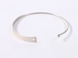a close up of a silver cuff bracelet on a white background