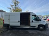 a white van parked in a parking lot with its doors open
