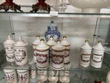 a glass display case with many different types of vases on it