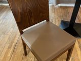 a brown chair and a black table in a room