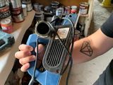 a man that is holding a drill in his hand