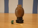 a small vase and a toothbrush sitting on a table