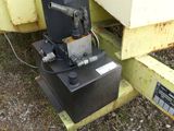 a machine that is sitting on the ground next to a box