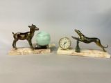 two figurines of a dog and a ball on a table