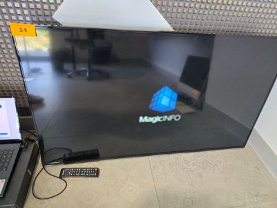 a laptop sitting on the floor next to a monitor