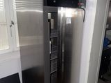 a stainless steel refrigerator in a kitchen with a window