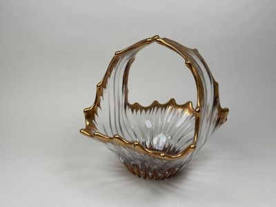 an image of a gold and clear glass basket on a white background
