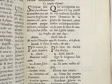 an open book with writing on it on a table