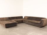 an image of a sectional couch and ottoman in a living room