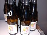 six bottles of wine are lined up on a counter top
