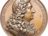 an image of a bronze medal with a man ' s face on it