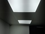 a picture of a room with a television and a ceiling light