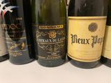 several bottles of wine are lined up on a table