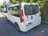 a small white van parked on the side of the road