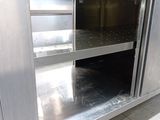 a stainless steel counter top with an open oven