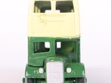 a green and yellow double decker bus on a white surface