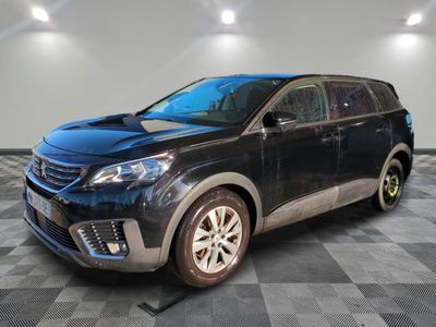 the black suv is parked in a large room with a checkered floor