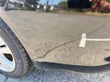a close up of a car ' s tire with a person taking a picture