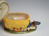 a small yellow bowl with a horse and carriage design on it