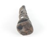 a small wooden object that is on a white surface