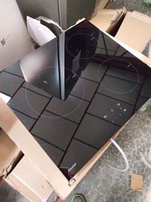 a black stove top sitting on top of a cardboard box