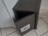 a small safe box in the corner of a bathroom