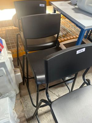many chairs and tables in a room with boxes on the floor