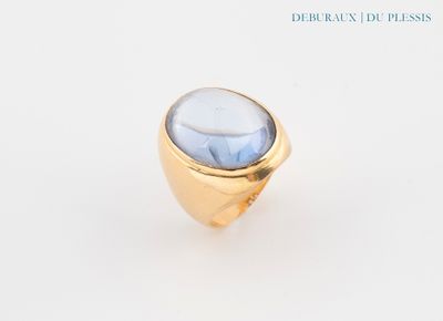 an image of a gold ring with a blue stone in it