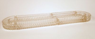 a clear plastic container with a handle on a white surface