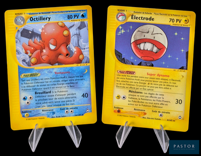 two pokemon cards that are on display on a table