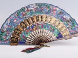 a fan that has a design on it and a tassel