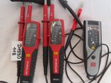 three electrical tools sitting on top of a table next to each other
