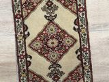 an image of a rug on a wooden floor next to a pair of shoes