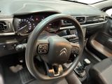 the interior of a car with a steering wheel and dashboard controls