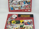 two comics books on a white surface with a red cover