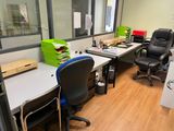 a desk with a chair and a computer on it