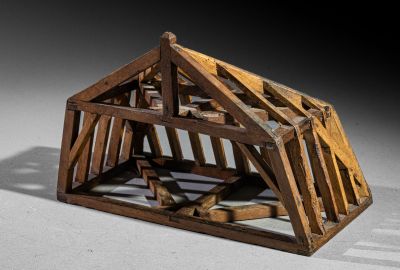 a small wooden structure with a roof made out of wood