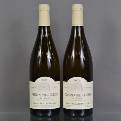 two bottles of wine sitting on top of a table next to each other