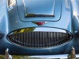 a close up of a blue car with a chrome grill